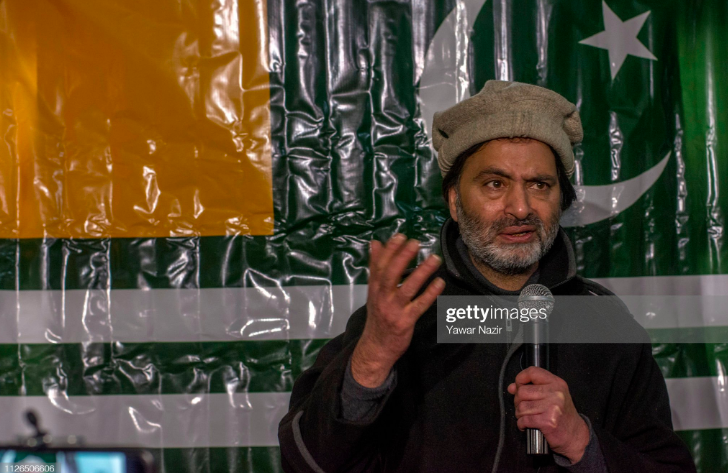 Yasin Malik giving a speech with the Kashmir map in the background.